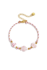 Armband mit Schildpatt- und Muschelperlen und Seilmotiv